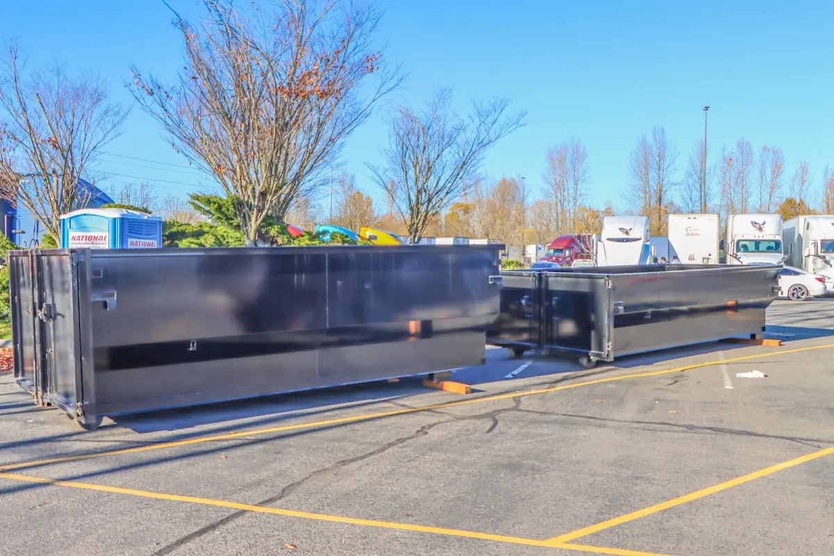 Professional dumpster rental service with roll-off container on residential driveway in Avenal